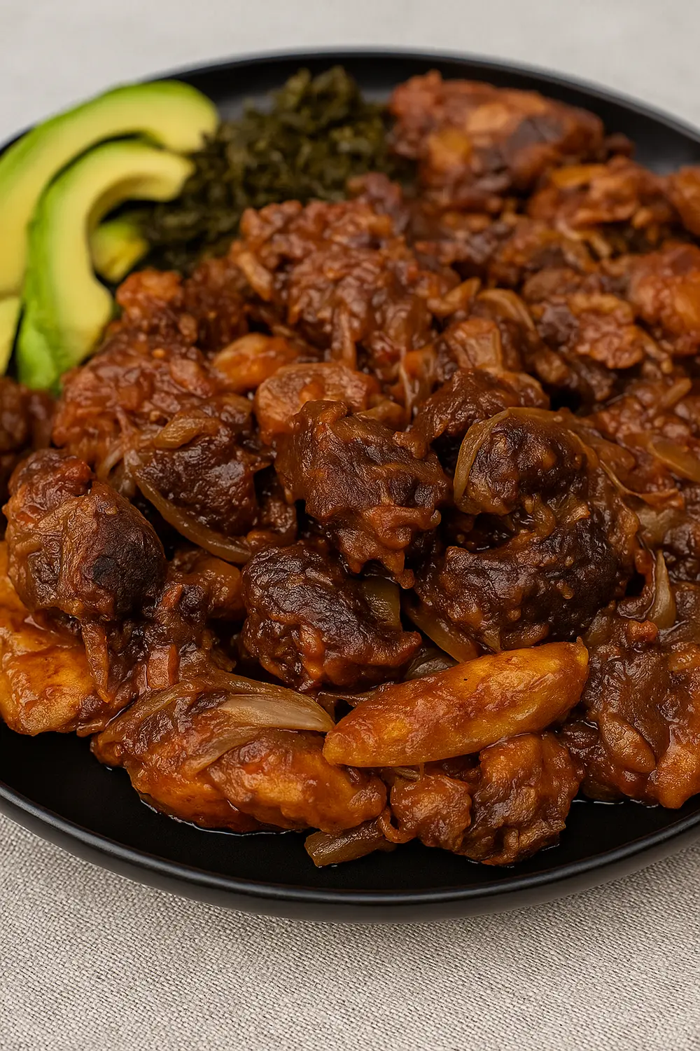 This low carbohydrate diet features Ugandan-style crispy pork stir fry, also known as Kikalayi pork, served with avocado slices, and cabbage.