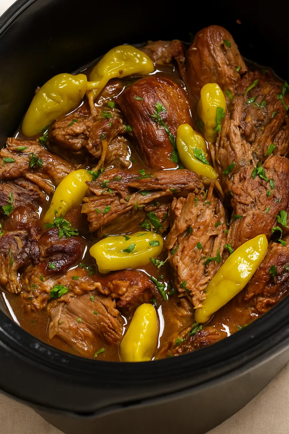 The best crockpot Mississippi pot roast beef with pepperoncini peppers and gravy, perfect for Christmas dinner with friends.